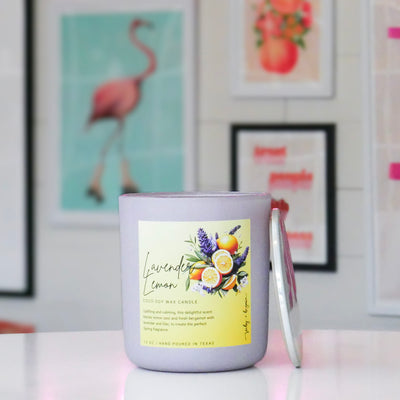 Purple candle with a yellow label featuring a bundle of lavender & lemons, titled 'lavender lemon'. 