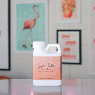 Smaller white laundry container labeled 'Sage & Timber'. 