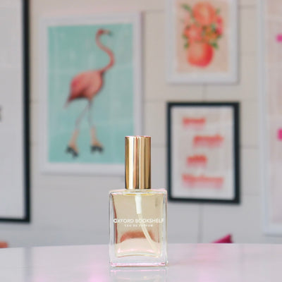 Clear glass perfume bottle with a gold cap, titled 'Oxford Bookshelf'. 