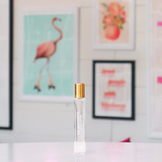 Clear rollerball perfume with gold cap labeled 'The Antoinette'. 