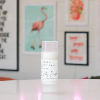 Body butter bar with a white label, titled 'Baby Powder'. 