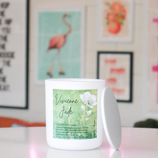 White candle with a green label featuring floral design, labeled Vivienne Jade.