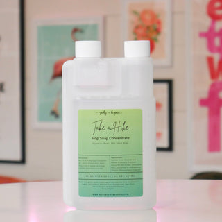 Bottle of mop soap concentrate with a green label, titled 'Take a Hike'. 
