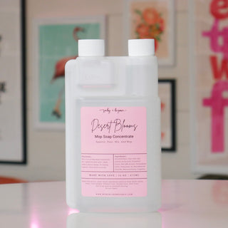 Mop soap concentrate with a pink label, titled 'Desert Blooms'. 
