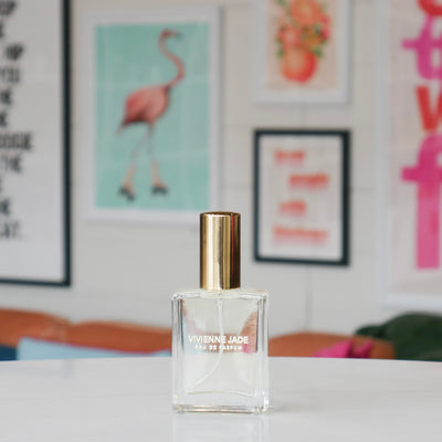Clear glass perfume bottle, labeled Vivienne Jade. 