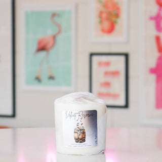 Smaller candle wrapped in white paper, titled 'Velvet Reserve'.