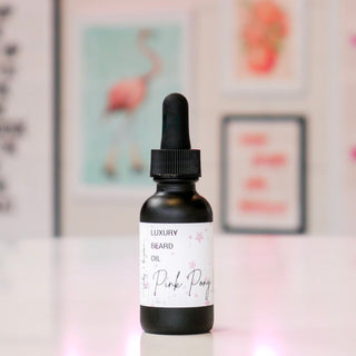 Black bottle of luxury beard oil with a dropper labeled 'Pink Pony Club'.