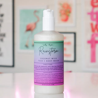 Bottle of coconut milk face & body wash with a blue/purple label, titled 'Rainstorm'.