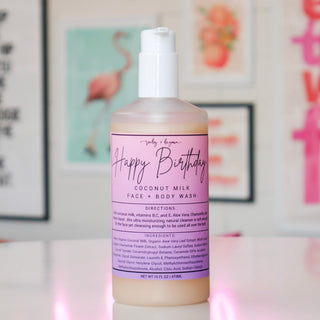 Coconut milk face and body wash bottle with a purple label, titled 'Happy Birthday'. 